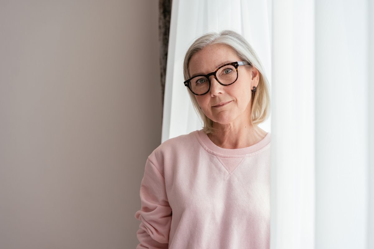 Elderly Woman in Pink Sweater Wearing Eyeglasses